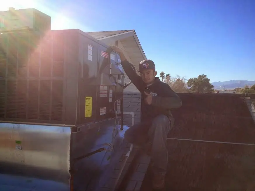HVAC technician performing Air Duct Cleaning on a rooftop unit in Mountain House